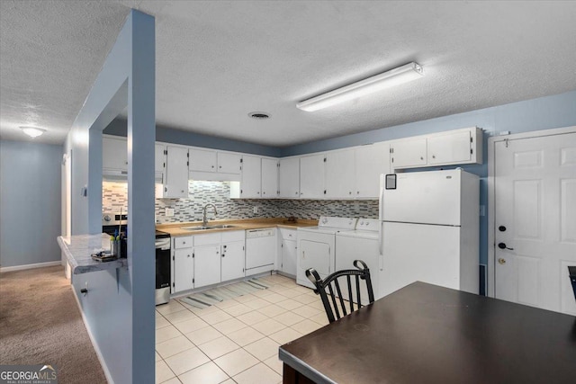 1777 Cedar Shoals Dr Unit 1775, Athens, GA 30605 - kitchen featuring white appliances, washer and clothes dryer, a textured ceiling, white cabinets, and tasteful backsplash