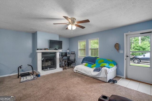 1777 Cedar Shoals Dr Unit 1775, Athens, GA 30605 - carpeted living room featuring a ceiling fan, healthy amount of natural light, a fireplace with raised hearth, and a textured ceiling