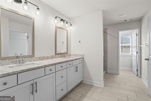 3382 Monarch Ave, Duluth, GA 30096 - bathroom featuring double vanity and a tile shower