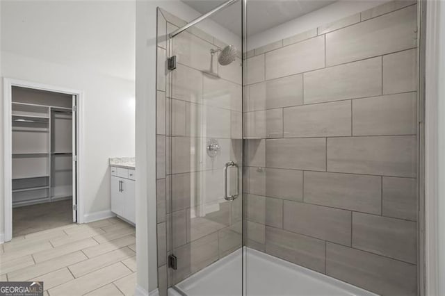 3382 Monarch Ave, Duluth, GA 30096 - full bathroom with a shower stall, a spacious closet, and vanity