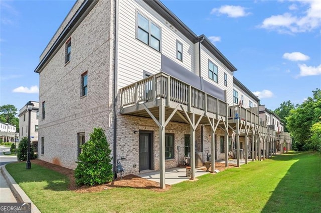 3382 Monarch Ave, Duluth, GA 30096 - rear view of house featuring a yard, brick siding, and a patio area
