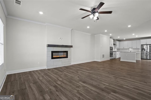 3382 Monarch Ave, Duluth, GA 30096 - unfurnished living room featuring ornamental molding, ceiling fan, recessed lighting, dark wood-style floors, and a fireplace