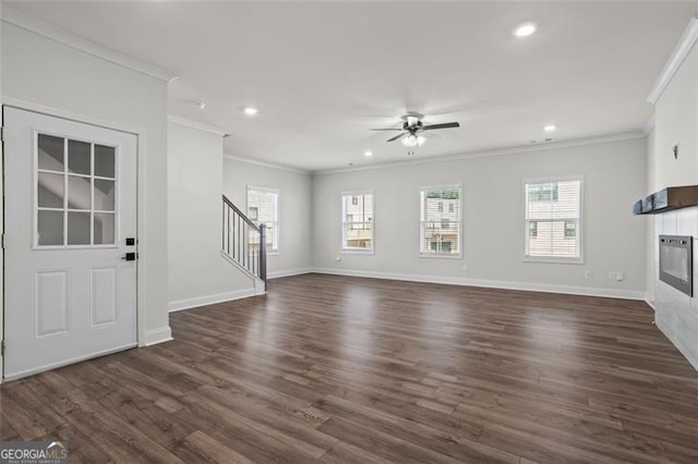 3382 Monarch Ave, Duluth, GA 30096 - unfurnished living room featuring ornamental molding, a ceiling fan, a tiled fireplace, dark wood-style flooring, and stairway