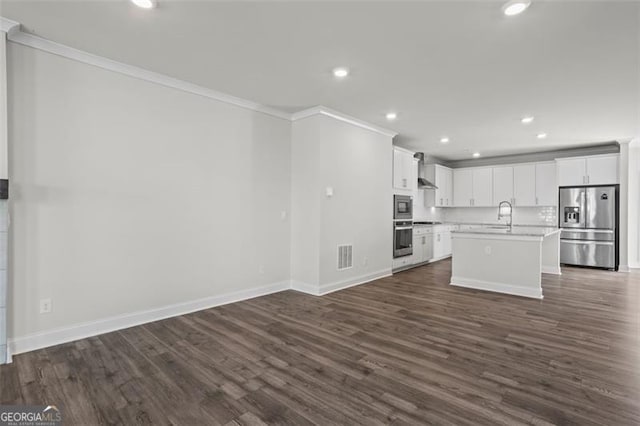 3382 Monarch Ave, Duluth, GA 30096 - kitchen with appliances with stainless steel finishes, crown molding, open floor plan, dark wood finished floors, and light countertops