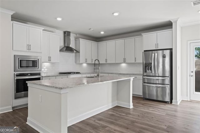3382 Monarch Ave, Duluth, GA 30096 - kitchen featuring stainless steel appliances, wall chimney exhaust hood, decorative backsplash, an island with sink, and recessed lighting