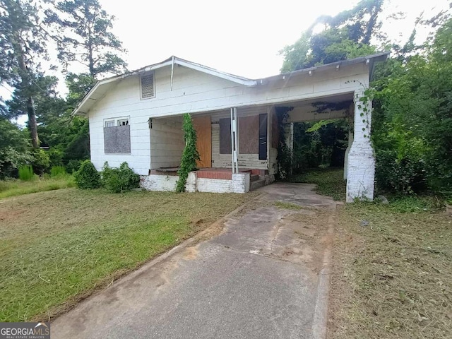 1168 Clinton Rd, Macon, GA 31211 - bungalow-style home featuring a porch, concrete driveway, and a front yard