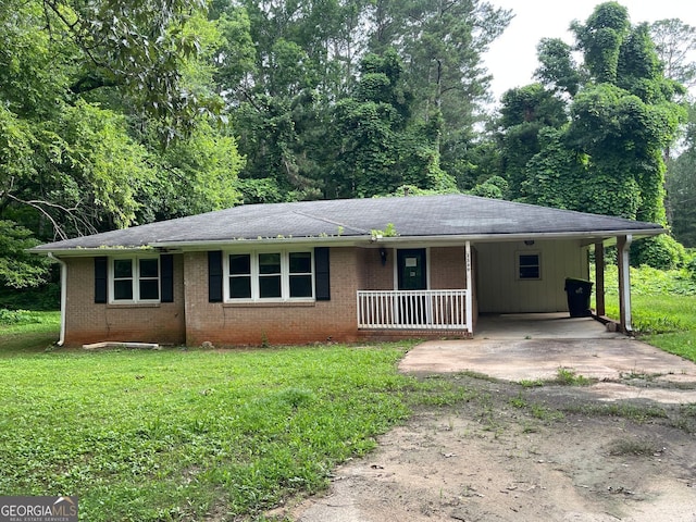 2369 Christian Cir, Covington, GA 30016 - single story home with driveway, a front yard, brick siding, and a porch