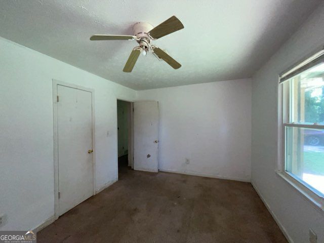 2369 Christian Cir, Covington, GA 30016 - unfurnished bedroom featuring carpet and ceiling fan