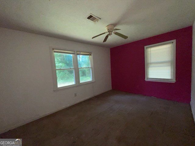 2369 Christian Cir, Covington, GA 30016 - carpeted spare room with ceiling fan
