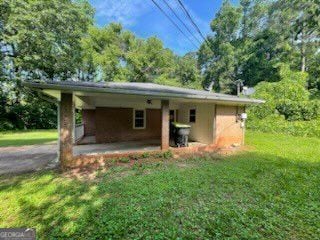 2369 Christian Cir, Covington, GA 30016 - view of front facade with an attached carport and a front lawn