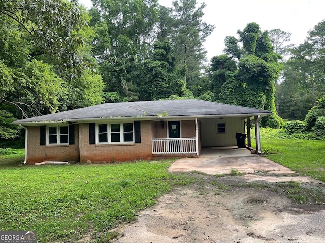 2369 Christian Cir, Covington, GA 30016 - ranch-style house featuring driveway, a front yard, brick siding, an attached carport, and covered porch