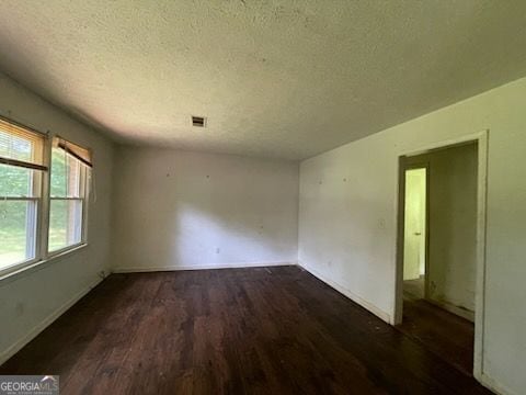 2369 Christian Cir, Covington, GA 30016 - spare room with wood finished floors and a textured ceiling