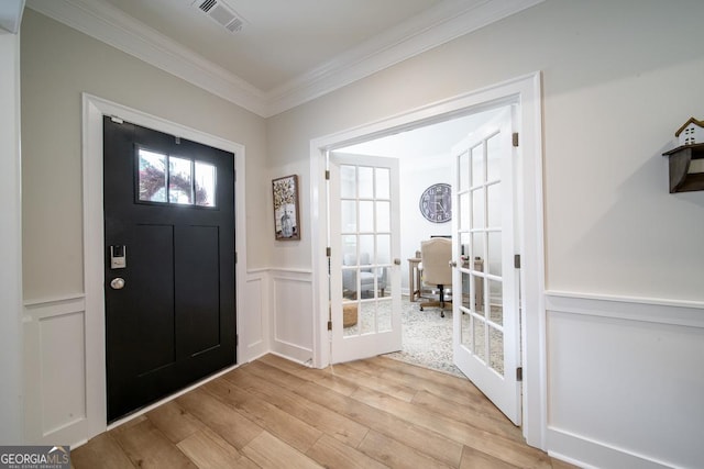 96 Cypress Trl, Fortson, GA 31808 - entrance foyer with ornamental molding, light wood-style floors, a decorative wall, and wainscoting