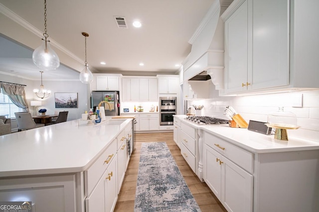 96 Cypress Trl, Fortson, GA 31808 - kitchen with appliances with stainless steel finishes, light wood-style flooring, light countertops, decorative backsplash, and white cabinets