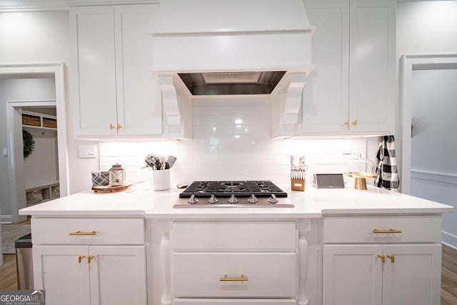 96 Cypress Trl, Fortson, GA 31808 - kitchen featuring stainless steel gas cooktop, white cabinets, and custom exhaust hood