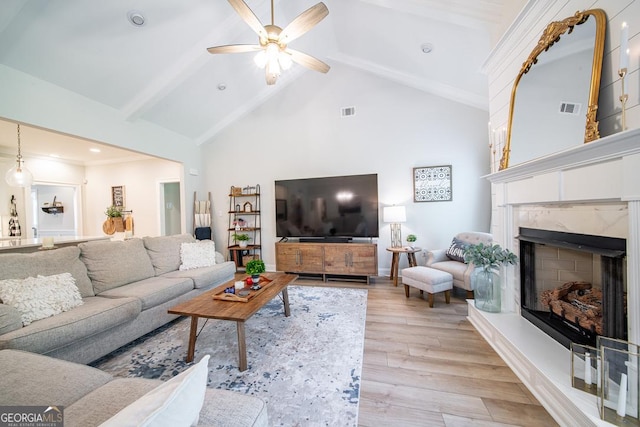 96 Cypress Trl, Fortson, GA 31808 - living area featuring light wood-style floors, a ceiling fan, a fireplace, beamed ceiling, and high vaulted ceiling