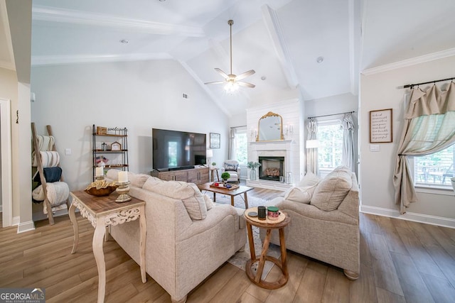 96 Cypress Trl, Fortson, GA 31808 - living area featuring a ceiling fan, wood finished floors, beam ceiling, a fireplace with raised hearth, and high vaulted ceiling
