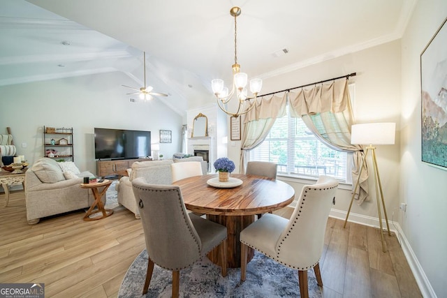96 Cypress Trl, Fortson, GA 31808 - dining area with a chandelier, light wood finished floors, a fireplace, ceiling fan, and ornamental molding