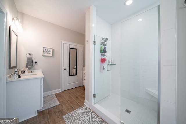 96 Cypress Trl, Fortson, GA 31808 - bathroom featuring vanity, a stall shower, wood tiled floors, and recessed lighting