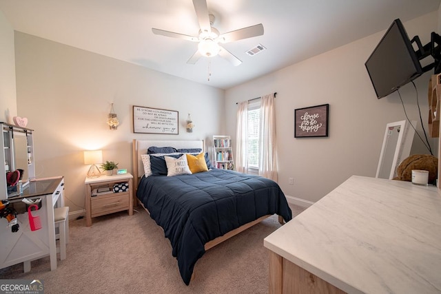 96 Cypress Trl, Fortson, GA 31808 - bedroom with light colored carpet, a barn door, and a ceiling fan