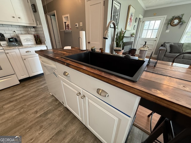 604 Spencer St, Barnesville, GA 30204 - kitchen featuring butcher block counters, crown molding, dark wood finished floors, decorative backsplash, and white cabinets