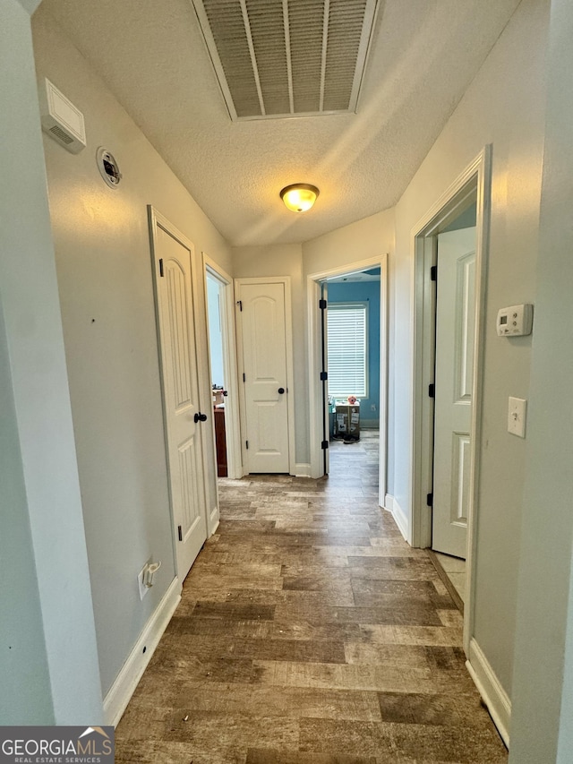 139 Raymond Cir, Warner Robins, GA 31088 - hallway featuring wood finished floors and a textured ceiling