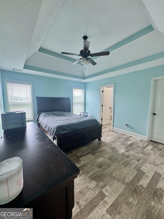 139 Raymond Cir, Warner Robins, GA 31088 - bedroom featuring a raised ceiling, a textured ceiling, and a ceiling fan