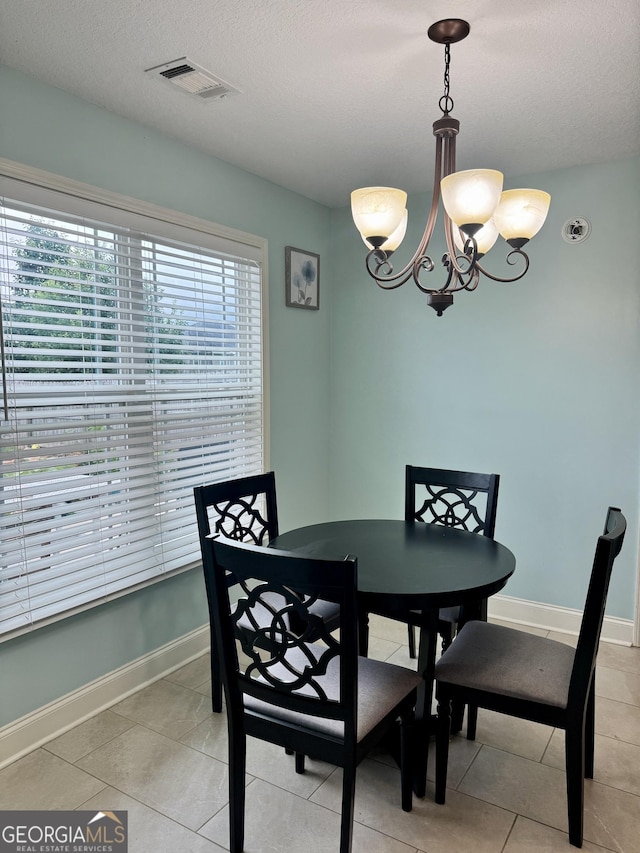 139 Raymond Cir, Warner Robins, GA 31088 - dining space featuring a chandelier, light tile patterned floors, and a textured ceiling