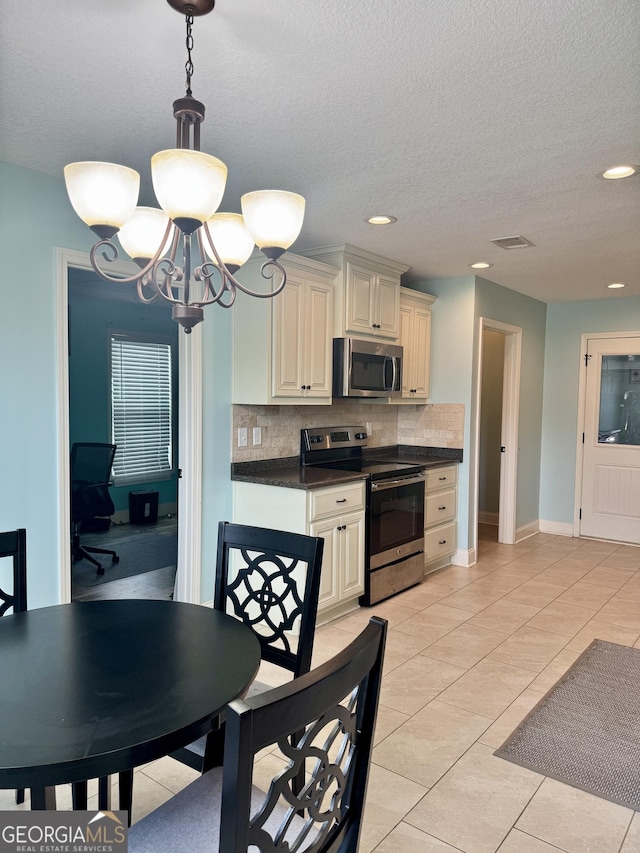 139 Raymond Cir, Warner Robins, GA 31088 - kitchen with appliances with stainless steel finishes, dark countertops, decorative backsplash, a chandelier, and recessed lighting