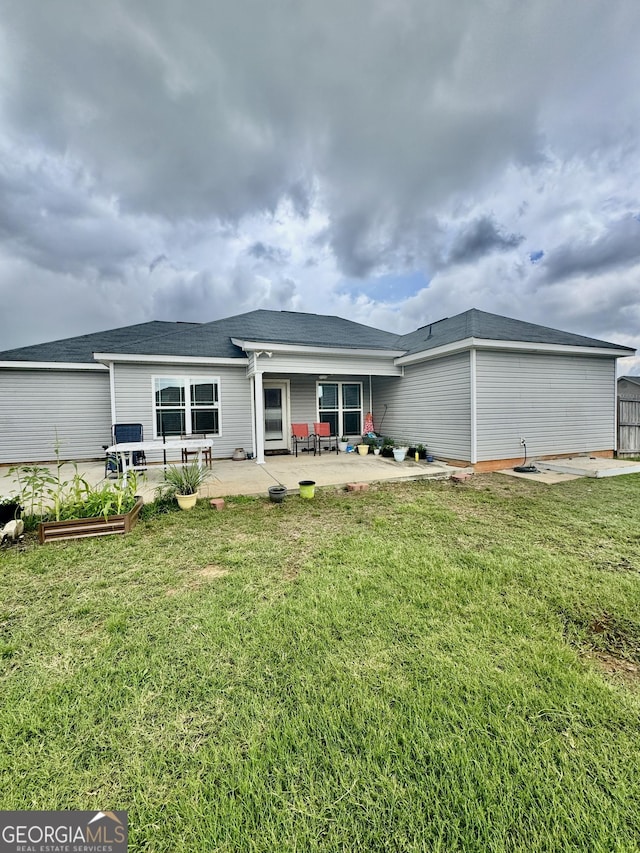 139 Raymond Cir, Warner Robins, GA 31088 - rear view of house featuring a patio area, a lawn, and a vegetable garden