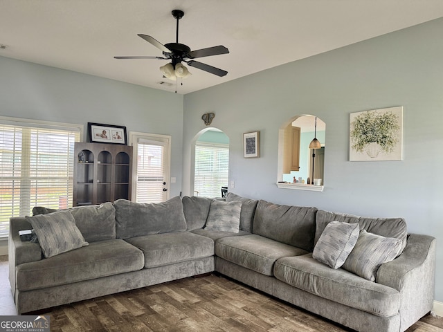 139 Raymond Cir, Warner Robins, GA 31088 - living room with dark wood-type flooring, plenty of natural light, ceiling fan, and arched walkways