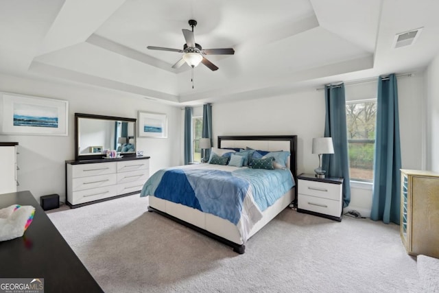 3225 Alhambra Cir, Hampton, GA 30228 - bedroom with a raised ceiling, light carpet, and ceiling fan