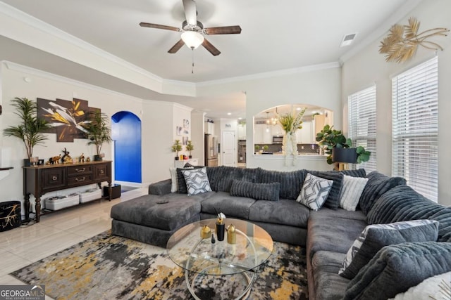 3225 Alhambra Cir, Hampton, GA 30228 - living room featuring a ceiling fan, arched walkways, light tile patterned flooring, and ornamental molding