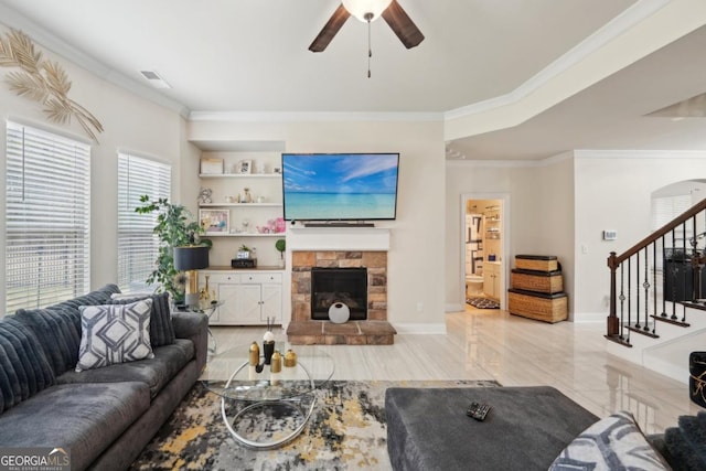3225 Alhambra Cir, Hampton, GA 30228 - living room featuring ceiling fan, crown molding, a fireplace, stairway, and built in shelves