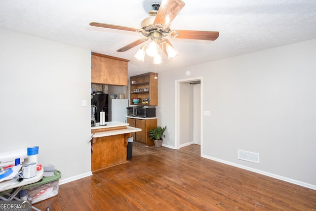 3470 Hill Ln, Acworth, GA 30102 - kitchen with brown cabinetry, dark wood finished floors, light countertops, ceiling fan, and open shelves