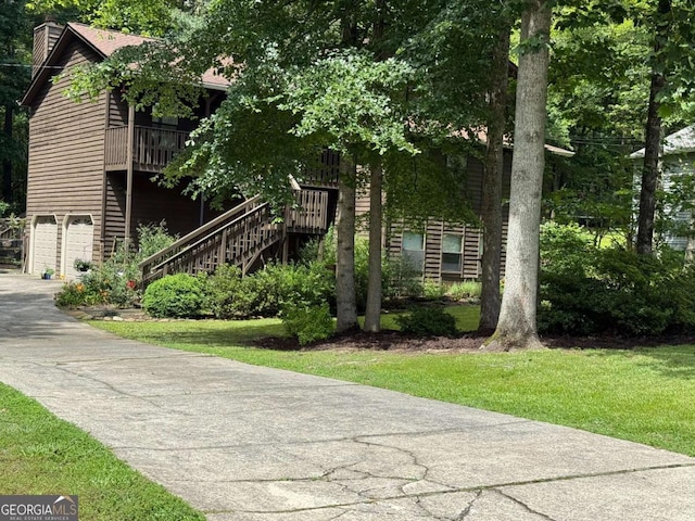 3470 Hill Ln, Acworth, GA 30102 - view of front of property featuring a chimney, an attached garage, stairs, driveway, and a front lawn