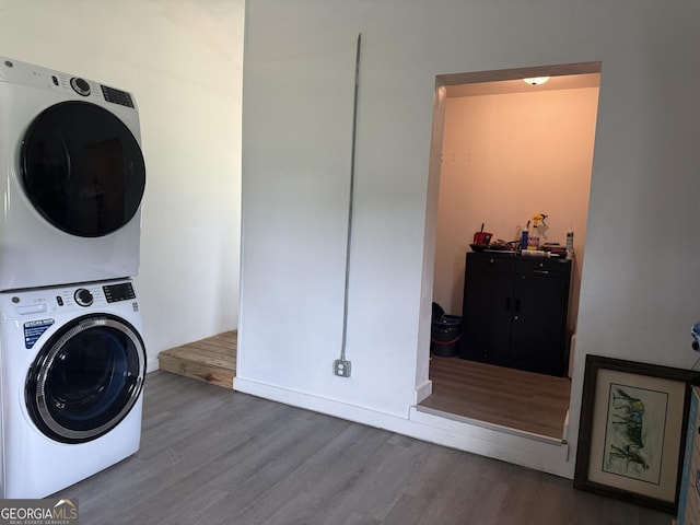 3052 Effingham Hwy, Sylvania, GA 30467 - laundry area with stacked washing machine and dryer and wood finished floors