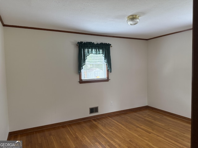 163 NW R St, Thomaston, GA 30286 - unfurnished room with crown molding, wood finished floors, and a textured ceiling
