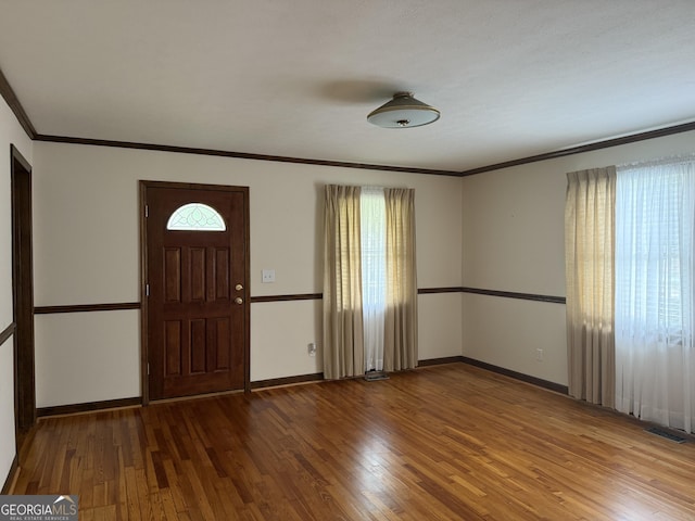 163 NW R St, Thomaston, GA 30286 - foyer entrance with healthy amount of natural light, wood-type flooring, and ornamental molding