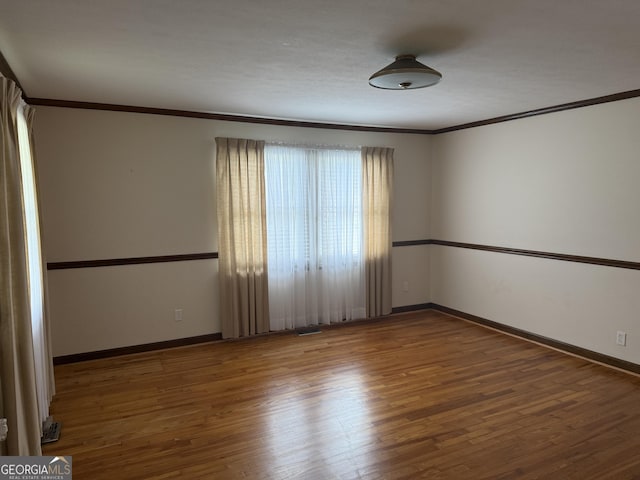 163 NW R St, Thomaston, GA 30286 - empty room featuring ornamental molding and wood finished floors