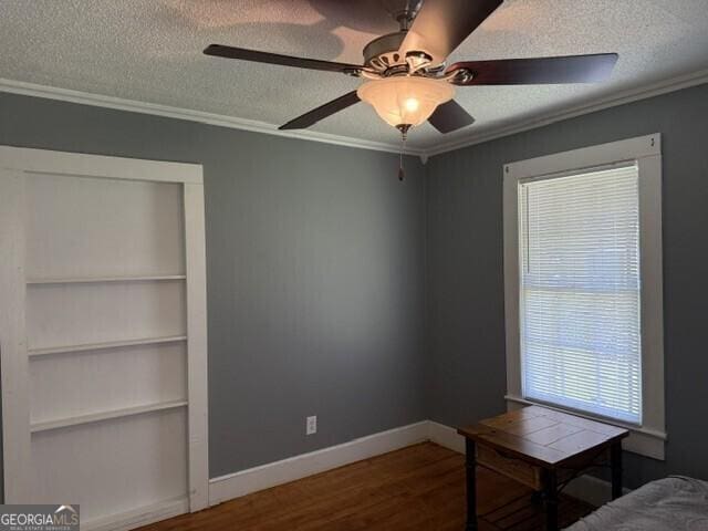 502 S Hull St, Sylvania, GA 30467 - unfurnished office with a textured ceiling, crown molding, built in features, wood finished floors, and ceiling fan