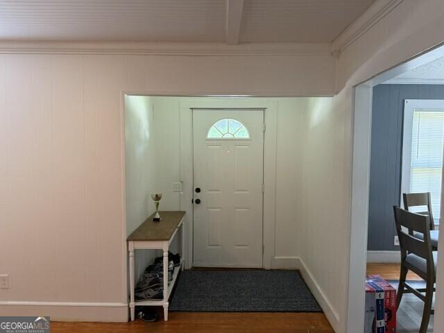 502 S Hull St, Sylvania, GA 30467 - entryway with wood finished floors, healthy amount of natural light, and beamed ceiling