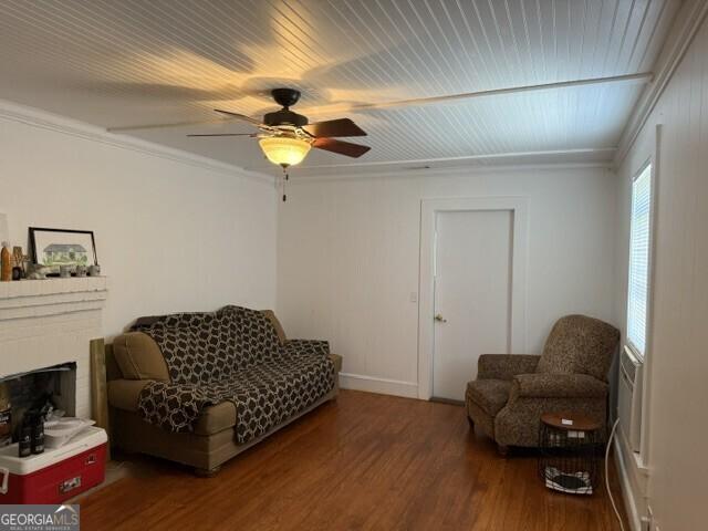 502 S Hull St, Sylvania, GA 30467 - sitting room featuring wood finished floors, ornamental molding, ceiling fan, and a fireplace