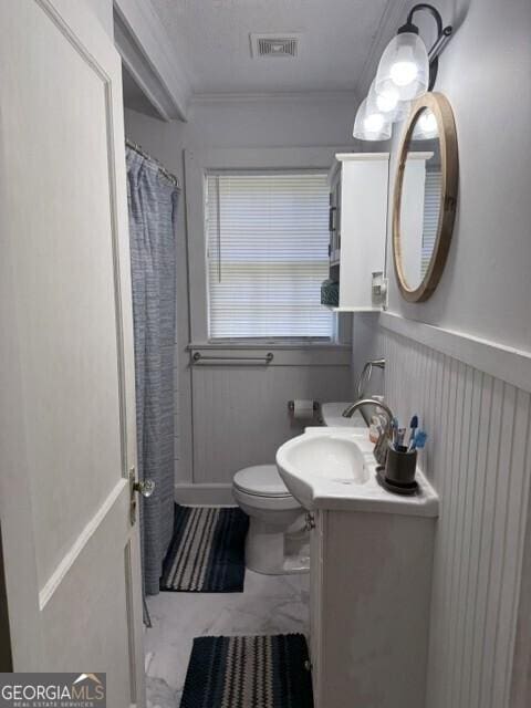 502 S Hull St, Sylvania, GA 30467 - bathroom featuring crown molding, vanity, wainscoting, and curtained shower