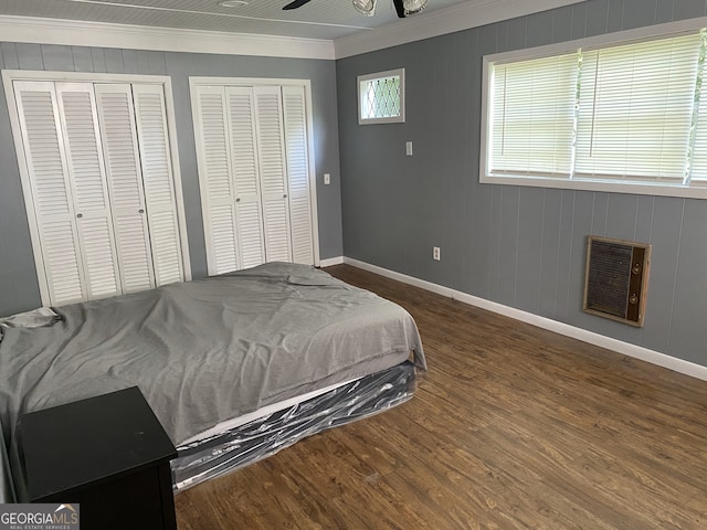 502 S Hull St, Sylvania, GA 30467 - bedroom featuring multiple closets, ornamental molding, wood finished floors, and heating unit