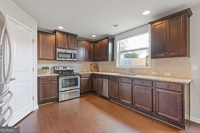 1238 New Liberty Way, Braselton, GA 30517 - kitchen featuring stainless steel appliances, dark wood-style flooring, light stone countertops, dark brown cabinetry, and recessed lighting