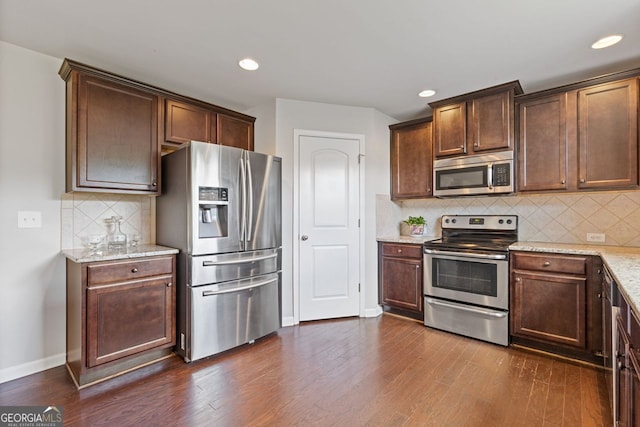 1238 New Liberty Way, Braselton, GA 30517 - kitchen with appliances with stainless steel finishes, dark wood-style floors, light stone counters, tasteful backsplash, and recessed lighting