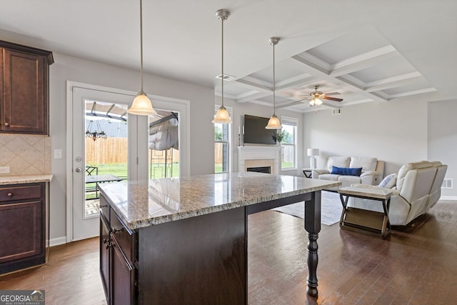 1238 New Liberty Way, Braselton, GA 30517 - kitchen with dark wood-style flooring, decorative backsplash, dark brown cabinetry, a ceiling fan, and light stone countertops