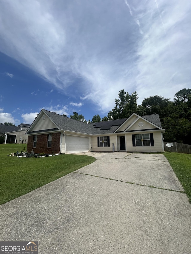 120 Silverbell Trce, Athens, GA 30606 - ranch-style home with concrete driveway, a front lawn, a garage, and roof mounted solar panels