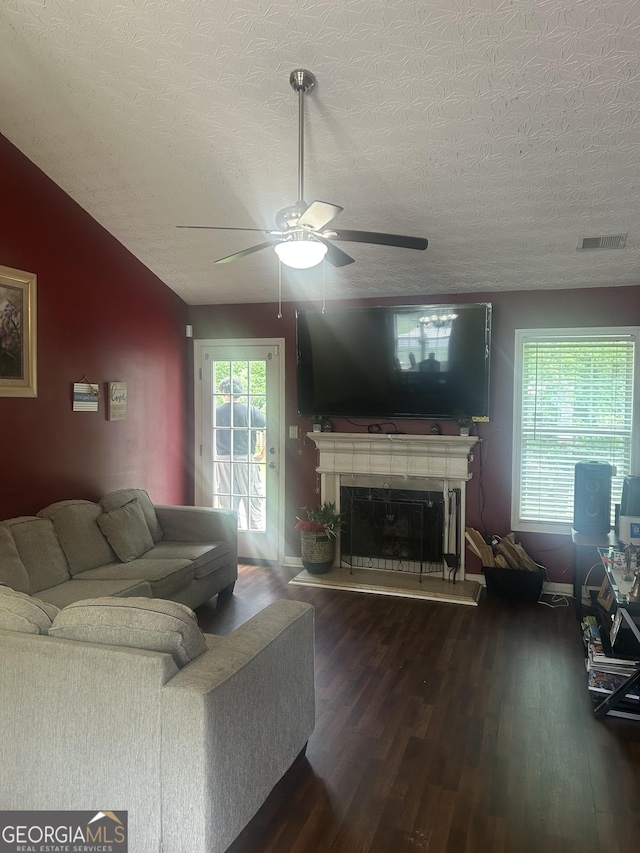 120 Silverbell Trce, Athens, GA 30606 - living room with ceiling fan, wood finished floors, a textured ceiling, and a fireplace with raised hearth